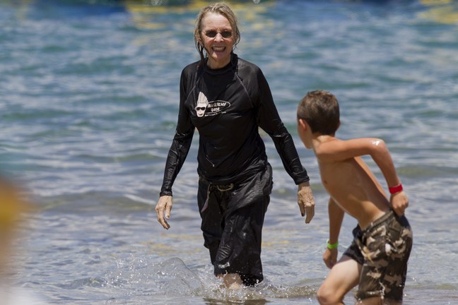 Diane Keaton, wetsuit, black shorts, black top, beach